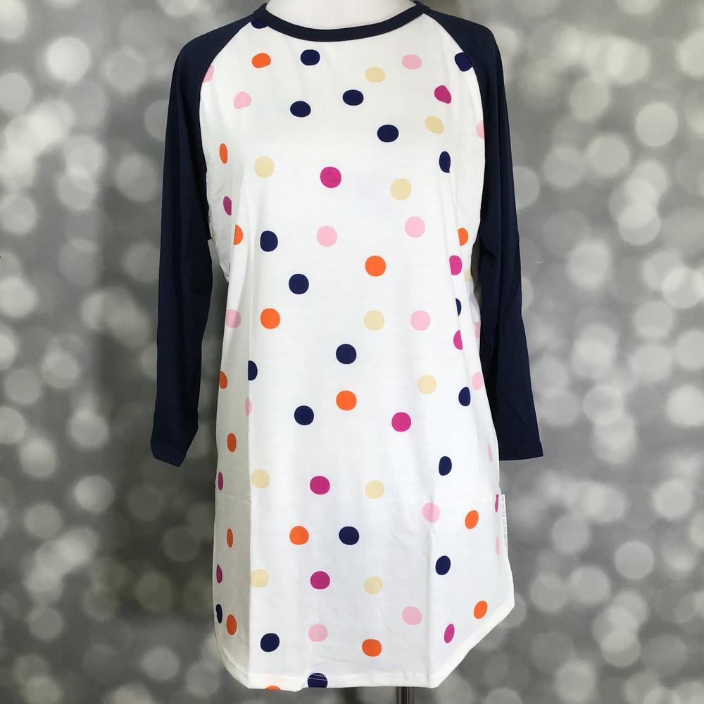 LuLaRoe Randy Tee with white base and multicolor polka dot print on a mannequin against a blurred background