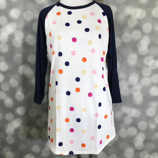 LuLaRoe Randy Tee with white base and multicolor polka dot print on a mannequin against a blurred background