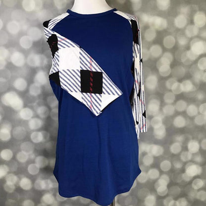 LuLaRoe Randy Tee with navy body and geometric striped contrast sleeves on mannequin on a gray blurred background