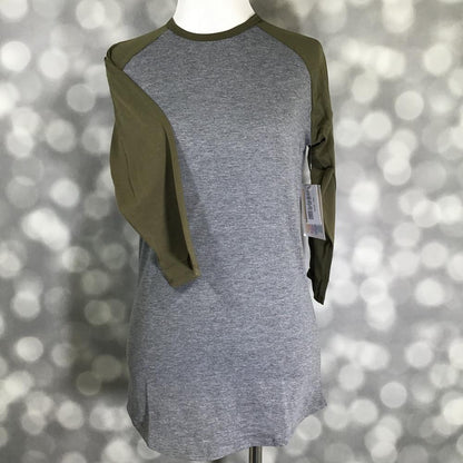 LuLaRoe Randy Tee with heather gray body and olive green long sleeves on a mannequin against a blurred background