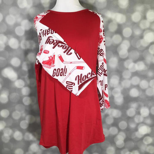 LuLaRoe Randy Tee with solid red body and white sleeves featuring red hockey-themed graphics on a mannequin