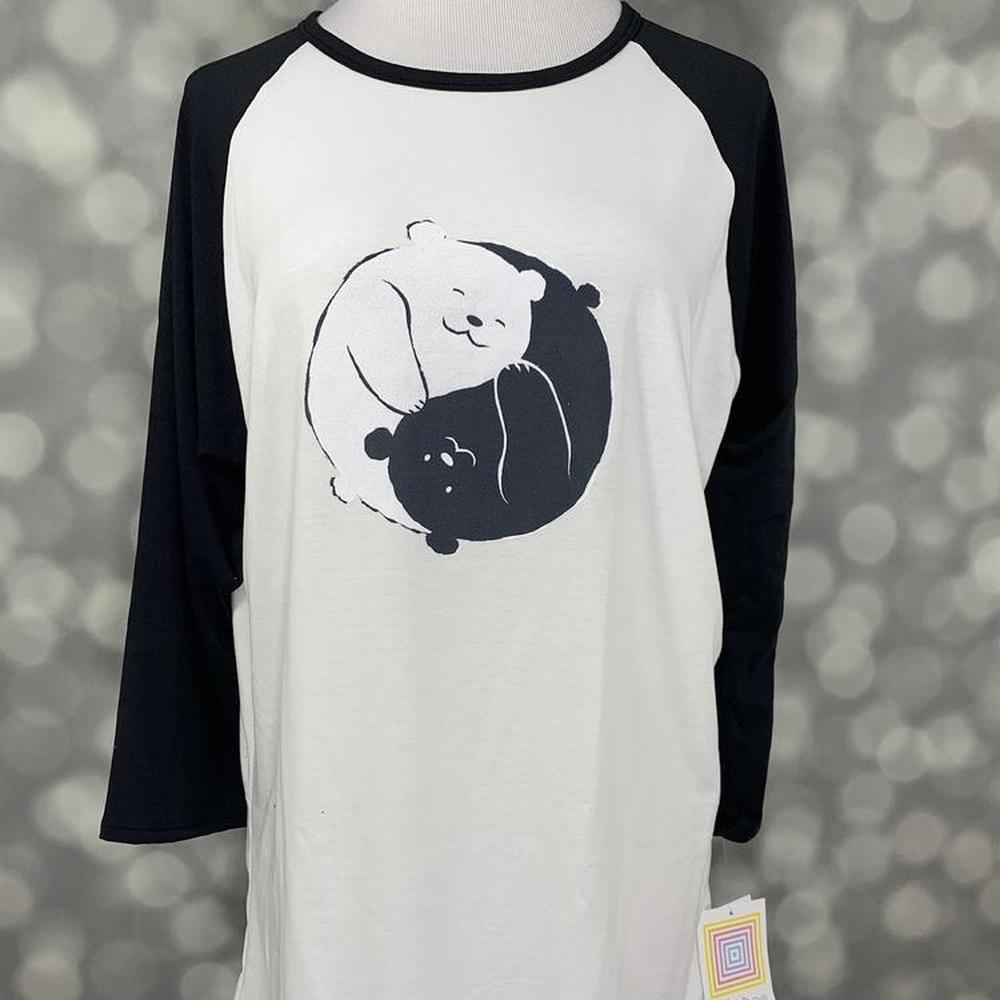 LuLaRoe Randy Tee with black sleeves and panda yin-yang graphic on cream body on a gray background