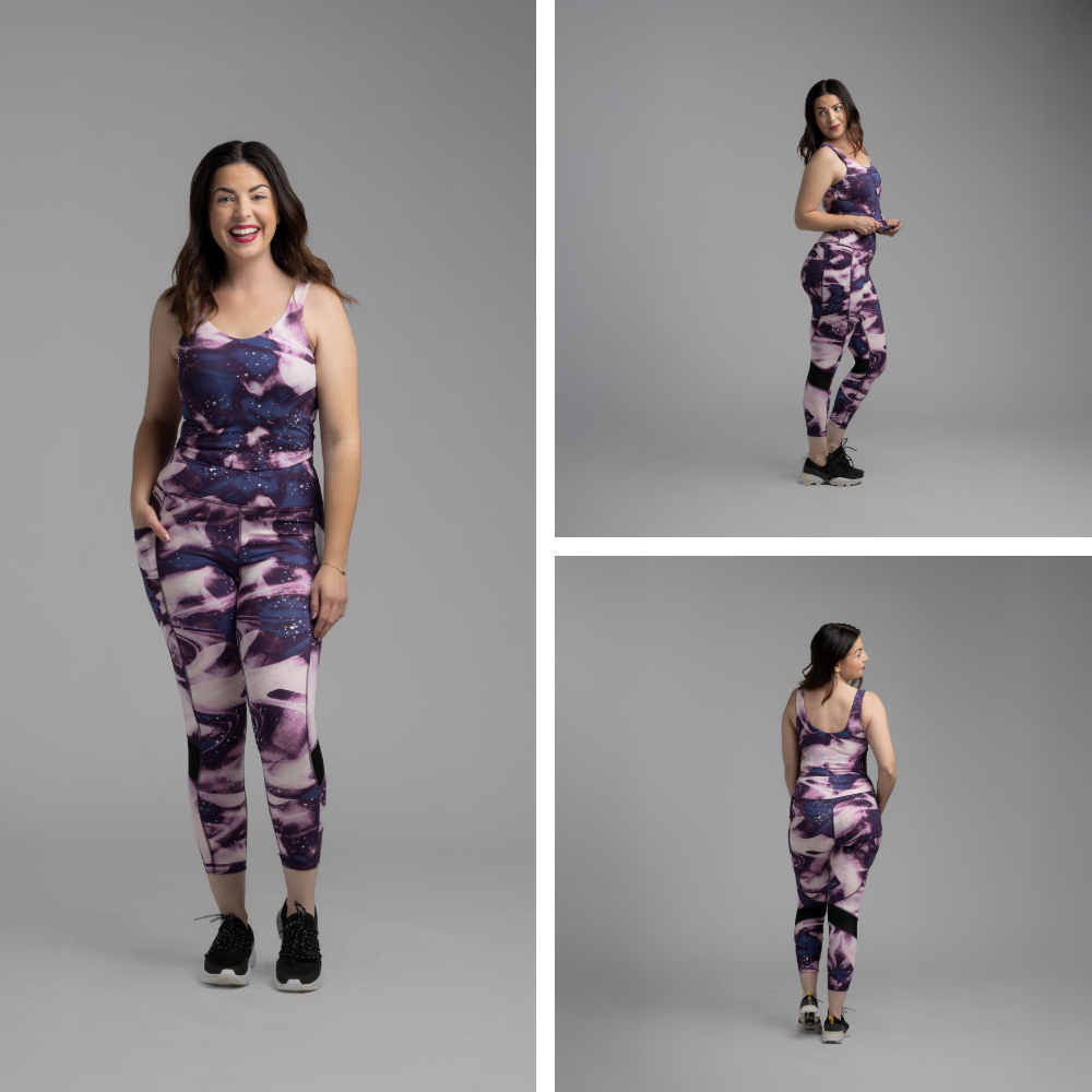 Woman modeling LuLaRoe Rise Fearless Crop Leggings in a purple galaxy-inspired marble print featuring shades of orchid, navy, blush lavender, and abstract watercolor swirls against a neutral gray studio background.