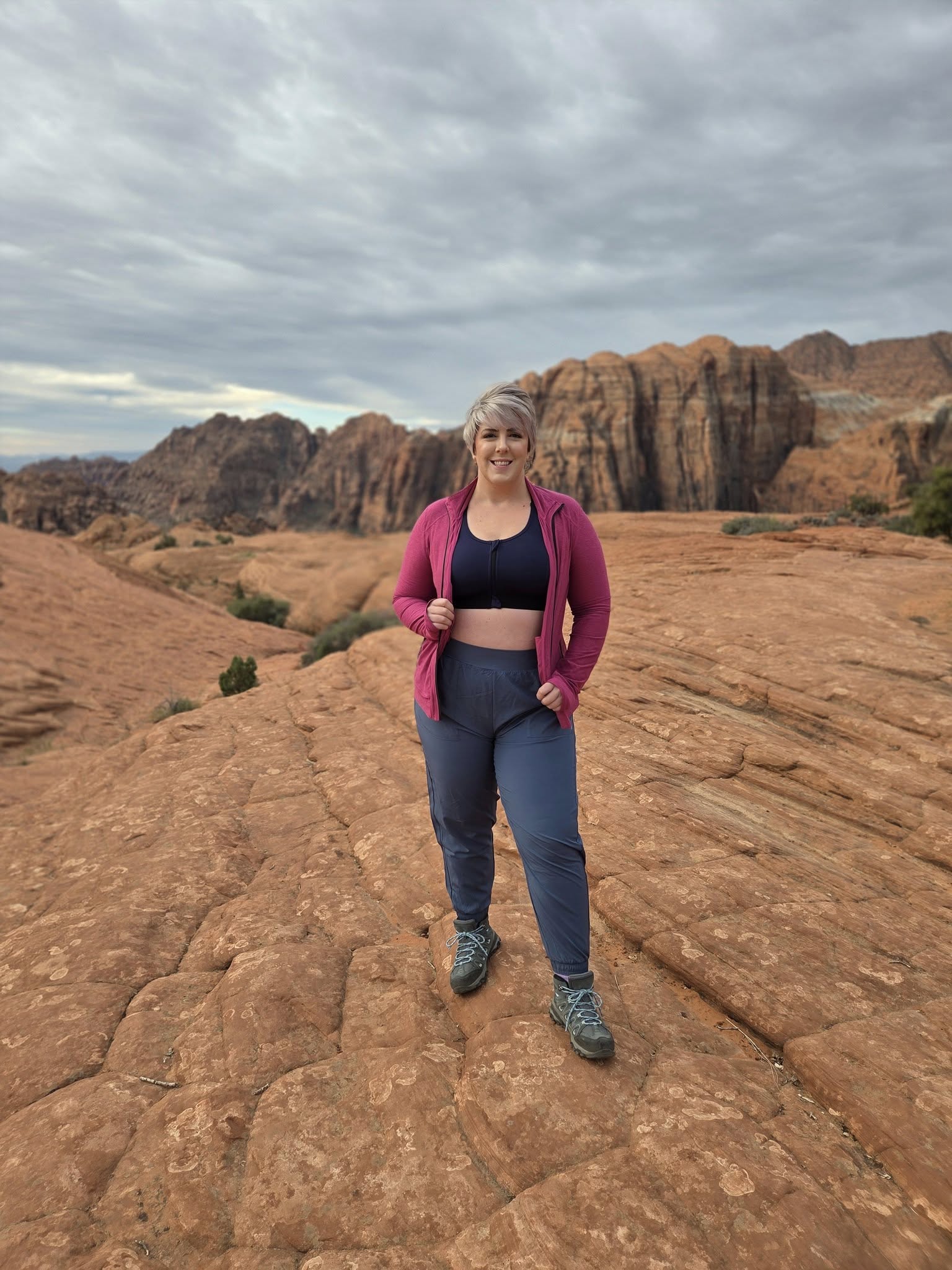 Model wearing LuLaRoe Rise Infinite Jogger in slate blue with a relaxed athletic fit, elastic waistband, and tapered jogger leg.