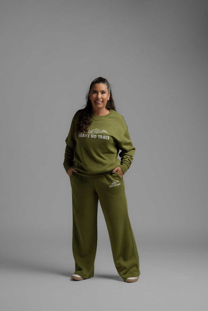LuLaRoe RISE Reset Crew Neck Pullover in moss green cotton blend fleece featuring Leave No Trace mountain graphic and relaxed loungewear fit against a gray background