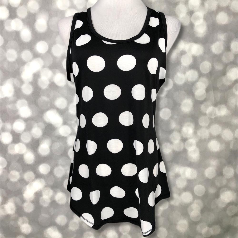 LuLaRoe black tank top with large white polka dot print, featuring a scoop neckline, sleeveless design, and relaxed fit displayed on a mannequin against a blurred background