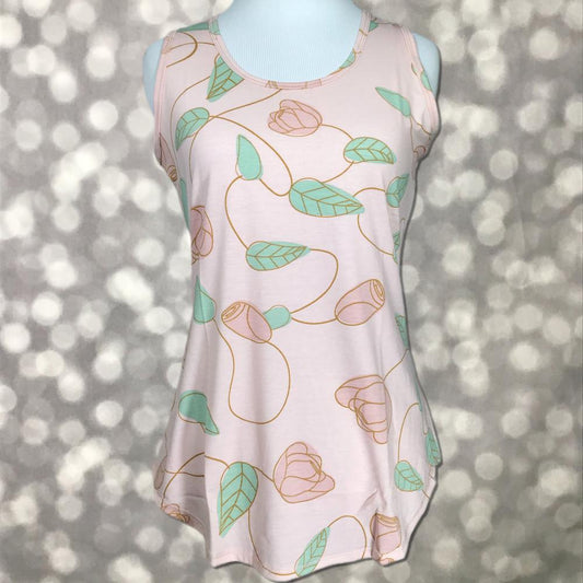 LuLaRoe blush pink tank top with mint green leaves and soft floral vine print, featuring a scoop neckline, sleeveless design, and relaxed fit displayed on a mannequin.