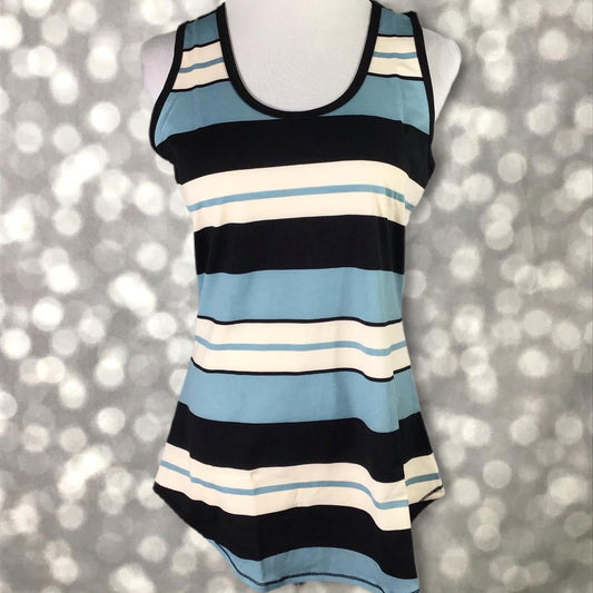 LuLaRoe tank top in Coastal Harbor Stripe featuring alternating sky blue, navy blue, and ivory horizontal stripes with a sleeveless silhouette, scoop neckline, and curved hem. Classic nautical-inspired women's tank top perfect for casual summer outfits, vacations, and everyday wear on a mannequin against a glittery silver background