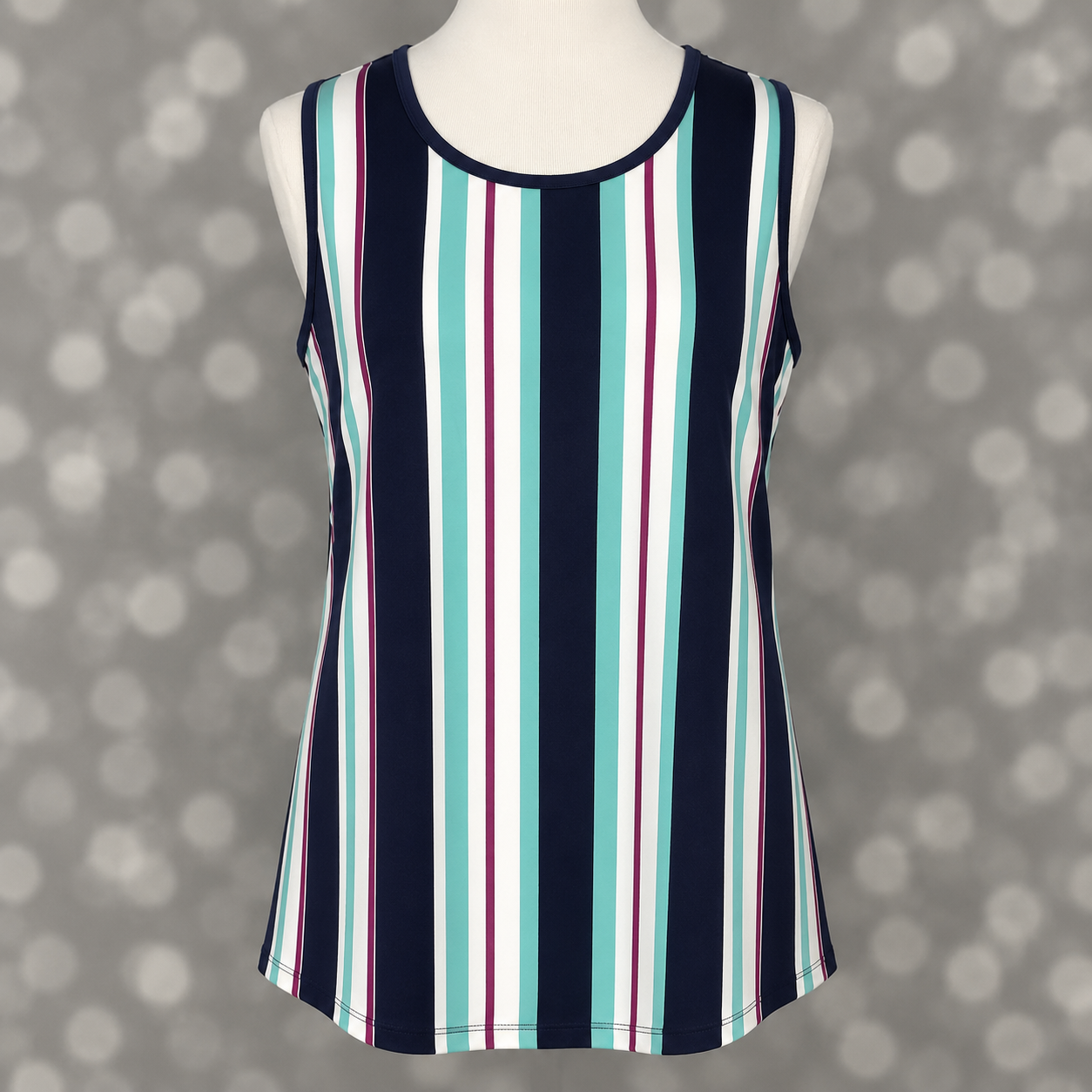 LuLaRoe tank top in Coastal Jewel Stripe featuring navy blue, aqua, white, and berry vertical stripes on a mannequin against a gray background. Sleeveless women's tank top with a scoop neckline and flattering elongated stripe design, perfect for casual outfits, vacation wear, and everyday boutique fashion.