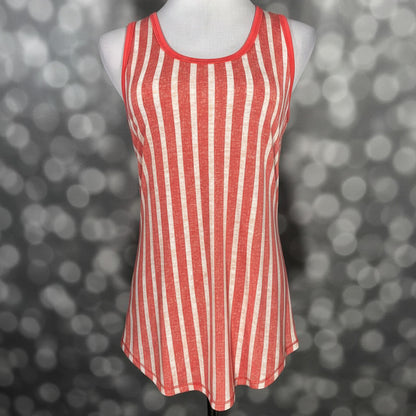 LuLaRoe coral and cream vertical striped tank top with scoop neckline, sleeveless design, and relaxed fit displayed on a mannequin against a blurred background