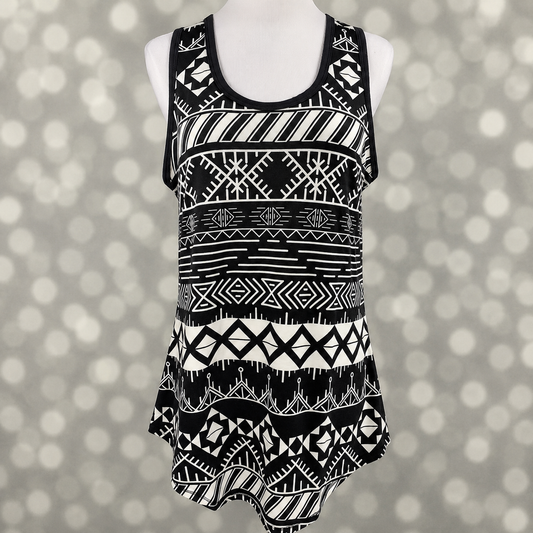 LuLaRoe tank top in Monochrome Mesa Mosaic featuring a bold black and white southwestern geometric pattern with tribal-inspired motifs, sleeveless styling, scoop neckline, and a relaxed fit. Women's boho tank top ideal for casual outfits, summer fashion, and everyday wear on a mannequin against a gray background