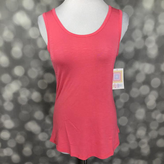 LuLaRoe solid coral pink tank top with scoop neckline, sleeveless design, and relaxed fit displayed on a mannequin against a blurred gray background
