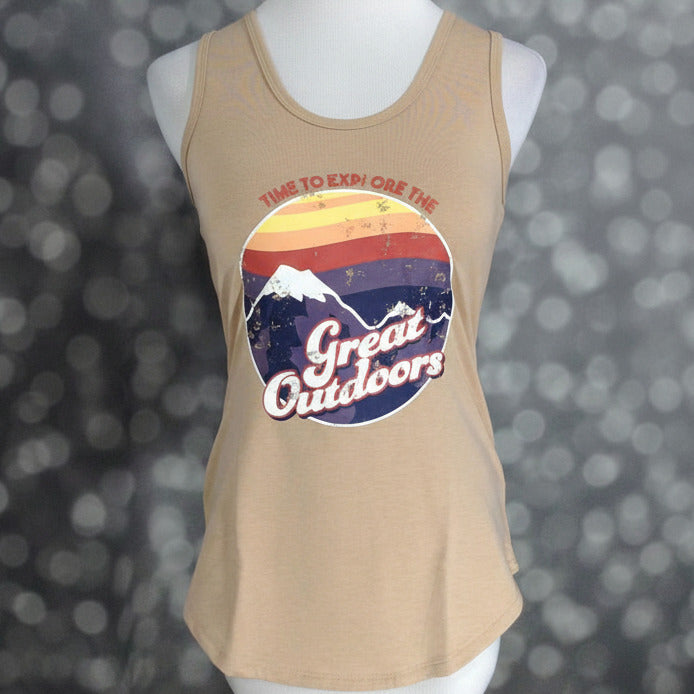 LuLaRoe tan sleeveless tank top with retro sunset mountain graphic and “Time To Explore the Great Outdoors” text, scoop neckline, and relaxed fit displayed on a mannequin against a blurred background