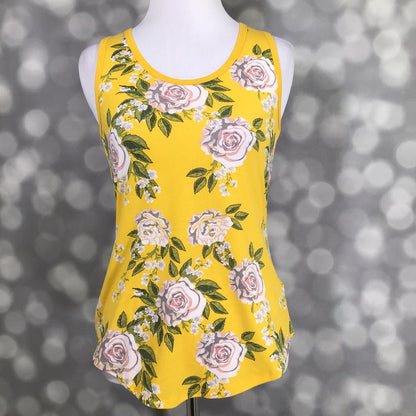 LuLaRoe yellow tank top with blush rose floral print and green leaves, featuring a scoop neckline, sleeveless design, and relaxed fit displayed on a mannequin against a blurred background
