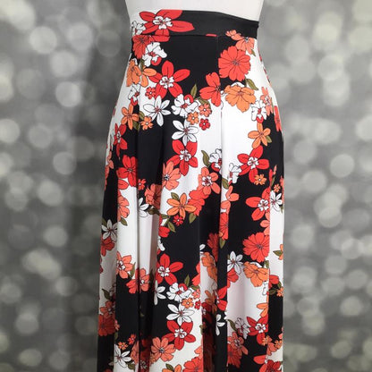 LuLaRoe Victoria skirt with black and white vertical stripes and coral orange floral print, featuring an elastic waistband and flowy midi silhouette displayed on a mannequin