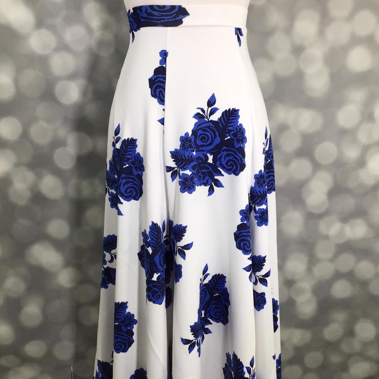 LuLaRoe Victoria skirt with white base and cobalt blue floral rose print, featuring an elastic waistband and flowy midi silhouette displayed on a mannequin