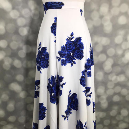 LuLaRoe Victoria skirt with white base and cobalt blue floral rose print, featuring an elastic waistband and flowy midi silhouette displayed on a mannequin