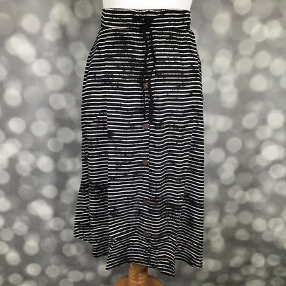 LuLaRoe Marsha Skirt with button-front detail featuring black and white horizontal stripe print with elastic waistband on a mannequin against a blurred background