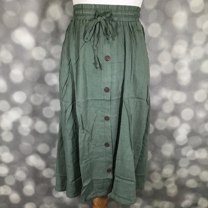 LuLaRoe Marsha Skirt Solid Sage Grove in muted green featuring a drawstring waist, button-front design, and easy everyday silhouette on a mannequin against a bokeh background