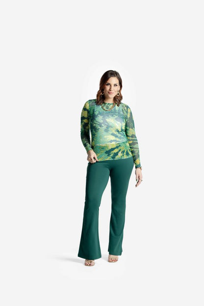Woman wearing a LuLaRoe May long sleeve mesh top in green abstract tie-dye pattern with fitted silhouette and lightweight semi-sheer mesh fabric styled on a white background