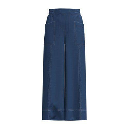 Model wearing the LuLaRoe Pull-On Patch Pocket Pant in Medium Wash with a wide-leg silhouette, drawstring waist and front patch pockets.