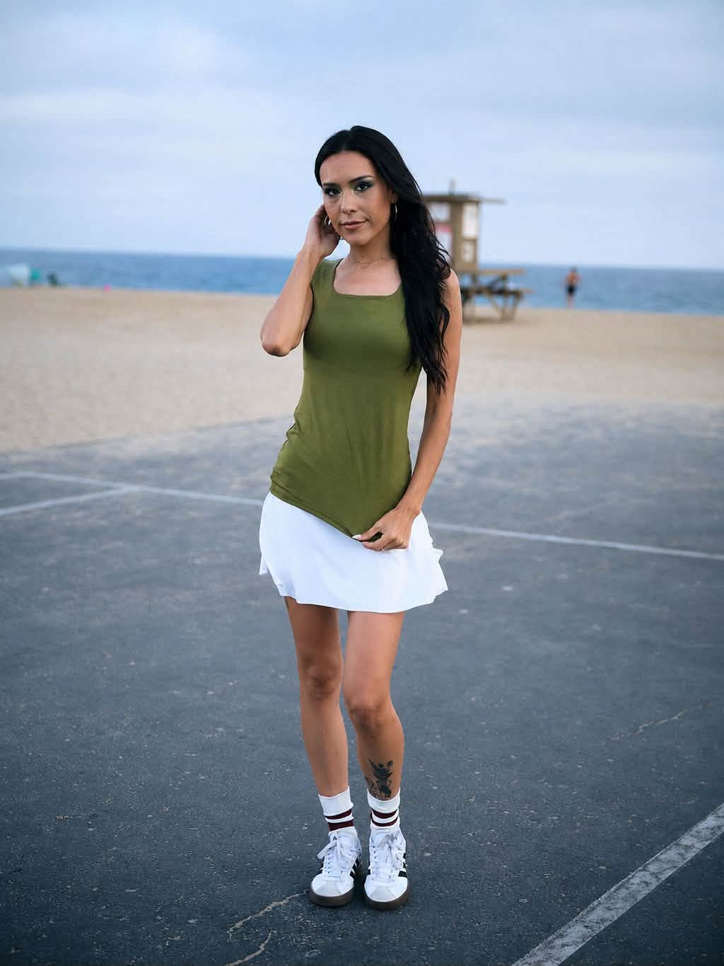 Model wearing the LuLaRoe Robyn Fitted Tank in solid olive green