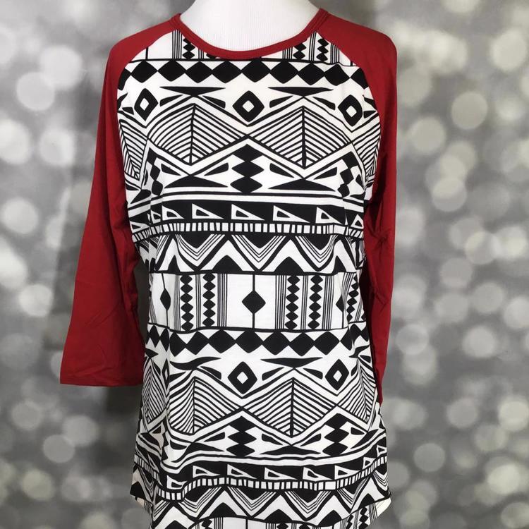 LuLaRoe Randy Tee with black and white geometric tribal print and red raglan sleeves on a mannequin.