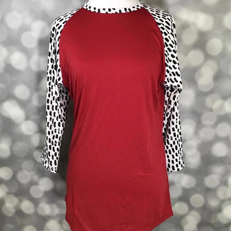 LuLaRoe Randy Tee in red with contrasting white and black spotted raglan sleeves and relaxed fit