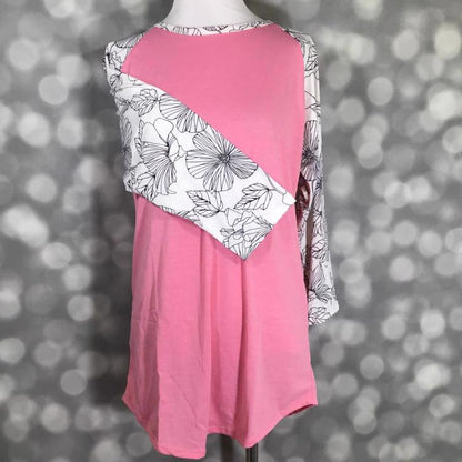 LuLaRoe Randy Tee with pink colorblock body and black and white floral line art print on a mannequin