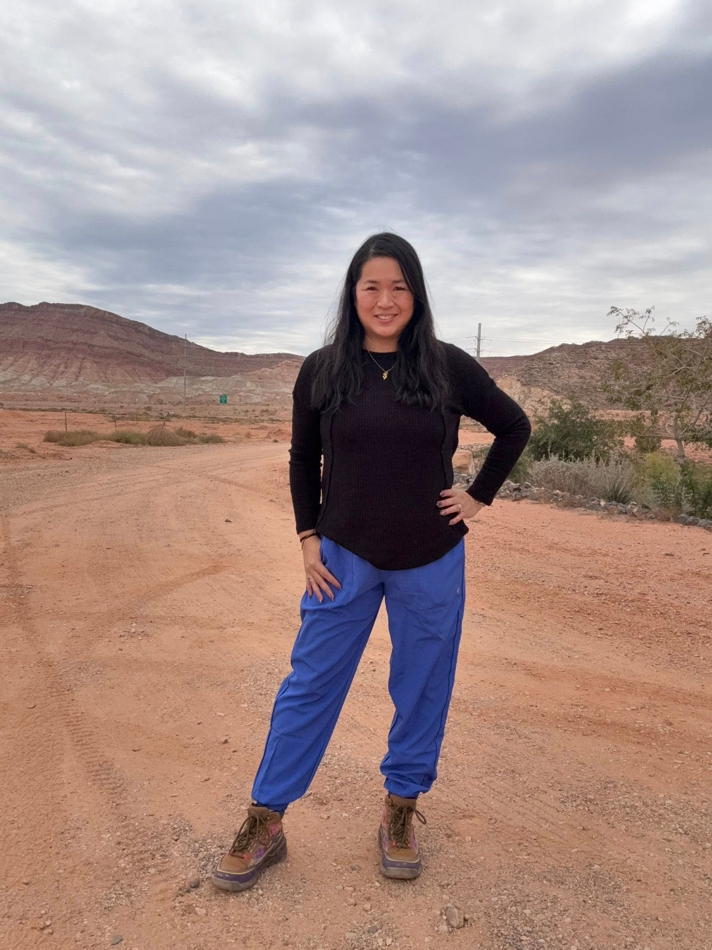 Model wearing LuLaRoe Rise Infinite Jogger in solid cobalt blue with elastic waistband and ankle cuffs