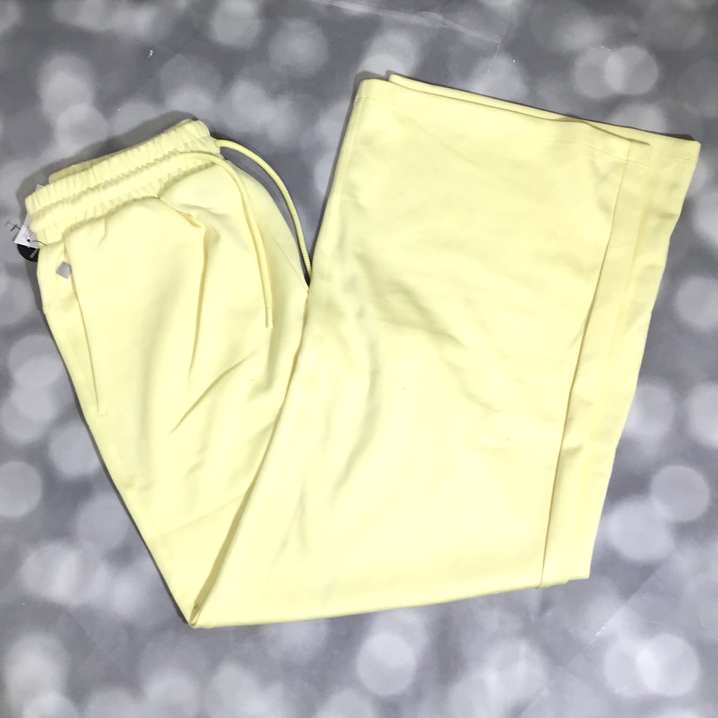 RISE Recharge pull-on sweatpant in solid buttercream yellow with a high-rise elastic waistband and wide leg fit. on a gray background