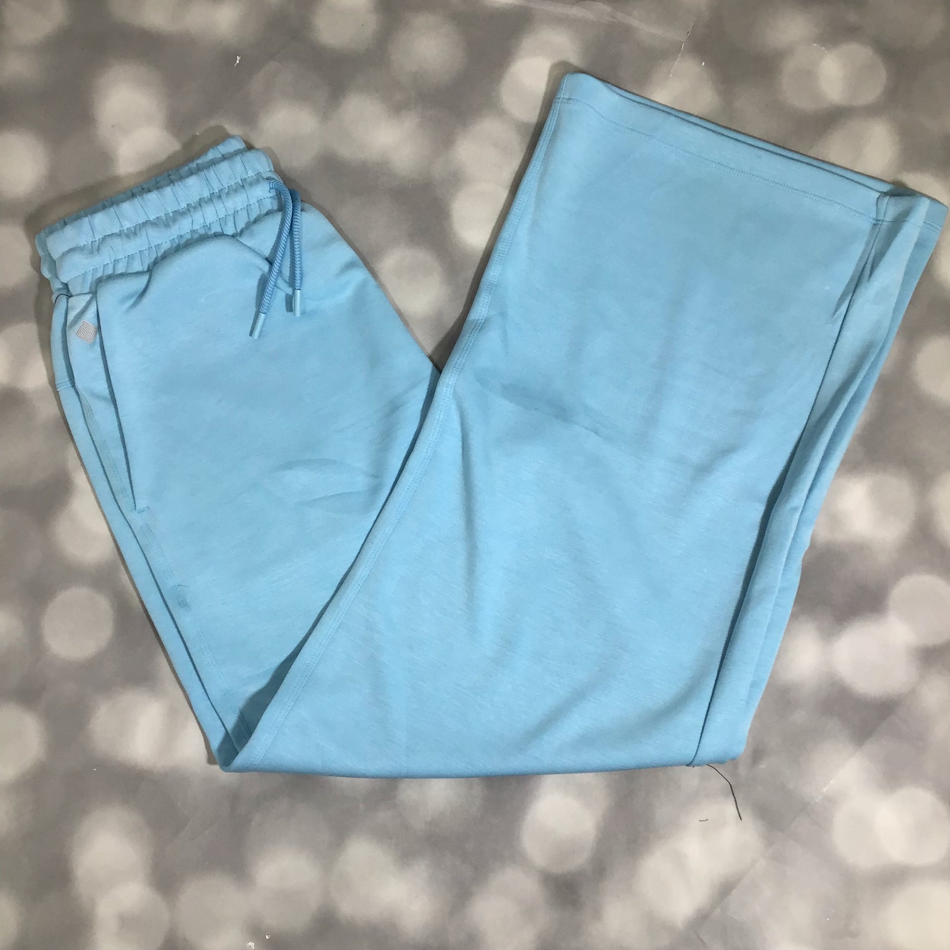 RISE Recharge pull-on sweatpant in solid cloud blue with a high-rise elastic waistband and relaxed wide leg on a textured gray surface