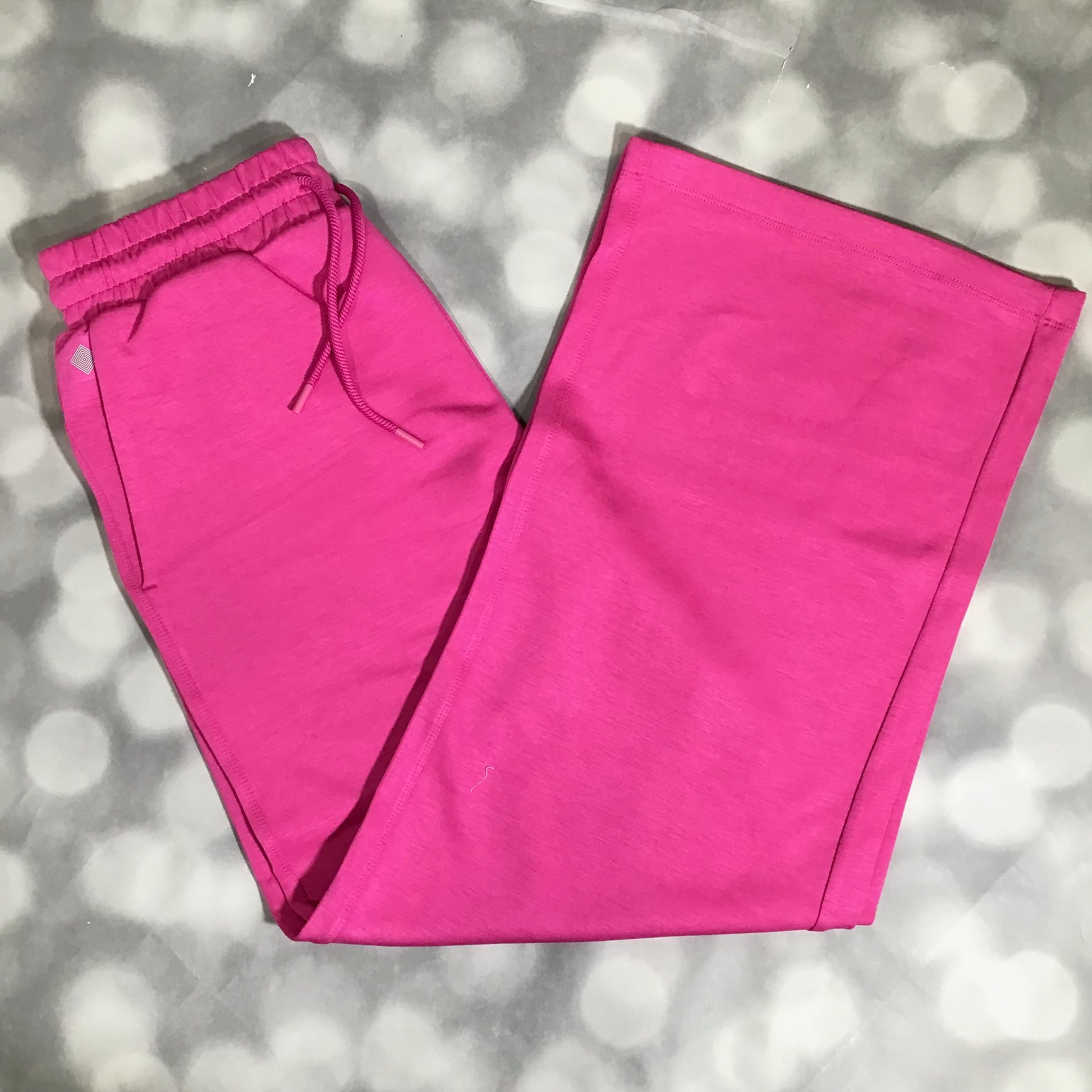 RISE Recharge pull-on sweatpant in solid vibrant fuchsia with a high-rise elastic waistband and wide leg fit on a gray background