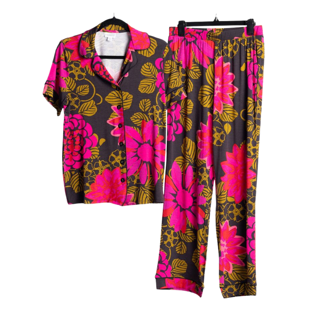 Two-piece Serene Set featuring a dark charcoal floral print short-sleeve button-front top with bright pink flowers and matching relaxed-fit lounge pants on a white background.
