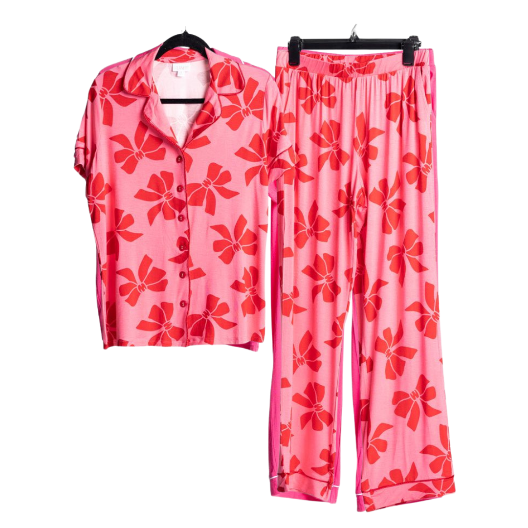 LuLaRoe Serene Set in pink with red ribbon bow print, featuring a relaxed button-front top and coordinating pull-on lounge pants for elevated everyday comfort against a white background