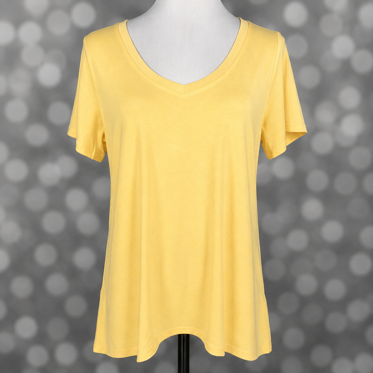 LuLaRoe Christy T in Solid Buttercup Yellow featuring a soft pastel yellow solid color, relaxed fit, V-neckline, short sleeves, and versatile everyday styling for women.