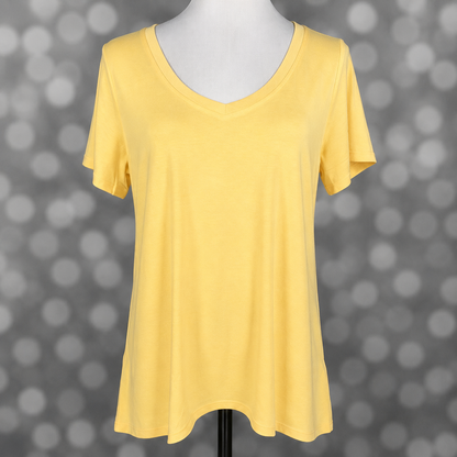 LuLaRoe Christy T in Solid Buttercup Yellow featuring a soft pastel yellow solid color, relaxed fit, V-neckline, short sleeves, and versatile everyday styling for women.