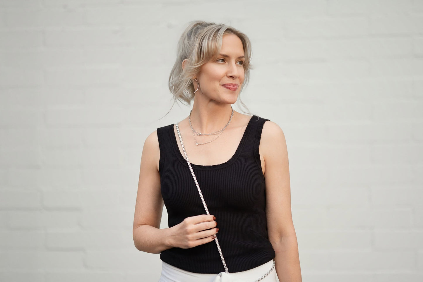 LuLaRoe Maydene Scallop Edge Tank in Solid Black with rib knit fabric, fitted silhouette, and scalloped neckline and arm openings. Alternate product image.