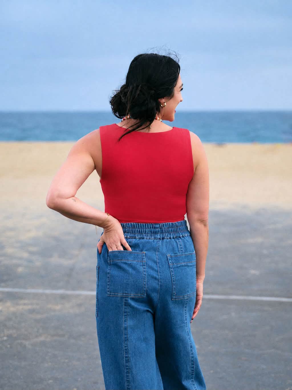 Model wearing the LuLaRoe Robyn Fitted Tank in solid crimson red